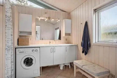 a bathroom with a washing machine and a sink at JB260-Fjerritslev-Blabaerstien-76 in Fjerritslev