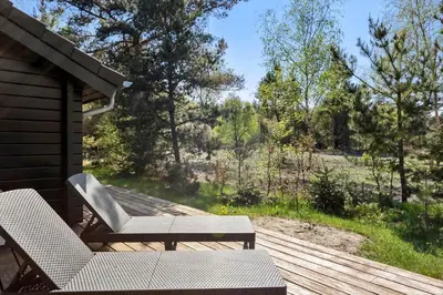 a patio with two chairs and a table on a deck at JB228-Brovst-Ildervej-14 in Brovst