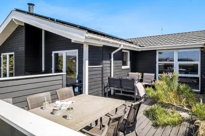 a patio with a table and chairs on a house at JB230-Frostrup-Grabakkevej-4 in Frøstrup