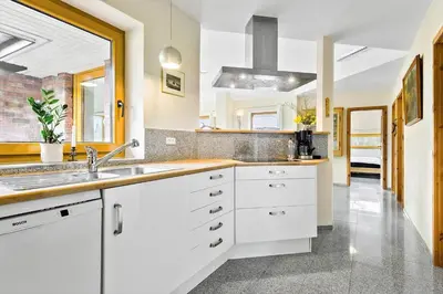 a kitchen with white cabinets and a sink at JB227-Frostrup-Andreas-Lassens-Vej-16 in Frøstrup