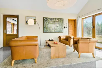 a living room with two chairs and a table at JB227-Frostrup-Andreas-Lassens-Vej-16 in Frøstrup
