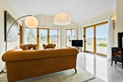 a living room with a couch and a tv at JB227-Frostrup-Andreas-Lassens-Vej-16 in Frøstrup