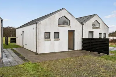 a white house with a black roof at JB308-Fjerritslev-Slettestrandvej-134-lejl-3 in Fjerritslev