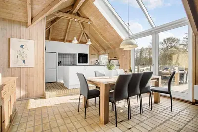 a kitchen and dining room with a table and chairs at JB149-Fjerritslev-Tulipanvej-23 in Fjerritslev