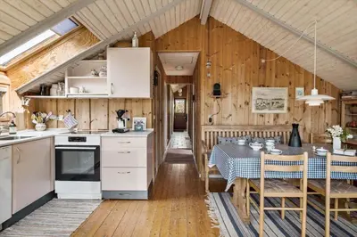 a kitchen and dining room with a table in a room at JB361-Fjerritslev-Lyngbjergvej-58 in Fjerritslev