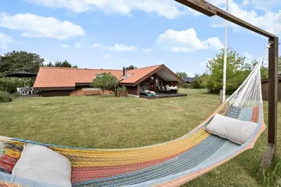 a hammock in a yard with a house at JB361-Fjerritslev-Lyngbjergvej-58 in Fjerritslev