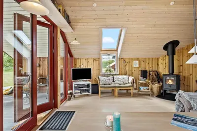 a living room with wood paneling and a fireplace at JB361-Fjerritslev-Lyngbjergvej-58 in Fjerritslev