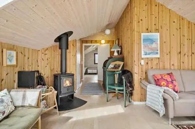 a living room with a wood stove in a room at JB361-Fjerritslev-Lyngbjergvej-58 in Fjerritslev