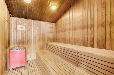 a wooden sauna with a red trash can in it at JB358-Brovst-Strandvejen-150-Lejl-126 in Brovst