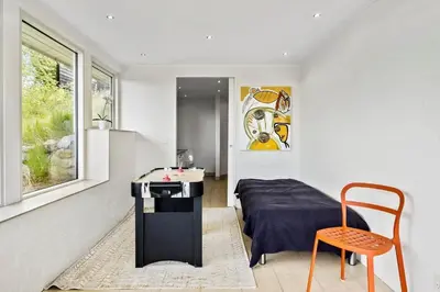 a bedroom with a bed and a table and a chair at JB400-Brovst-Solsortevej-7 in Brovst