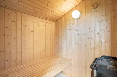 a sauna with wooden walls and a light fixture at JB209-Fjerritslev-Egevej-22 in Fjerritslev