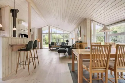a kitchen and living room with a table and chairs at JB209-Fjerritslev-Egevej-22 in Fjerritslev
