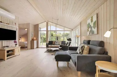 a living room with a couch and a tv at JB209-Fjerritslev-Egevej-22 in Fjerritslev