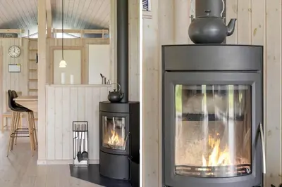 a living room with a fireplace with a stove at JB209-Fjerritslev-Egevej-22 in Fjerritslev