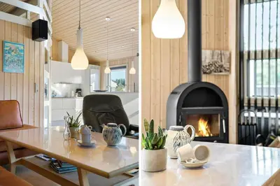 a living room with a table and a fireplace at LK1902-Lokken-Olgavej-40 in Løkken