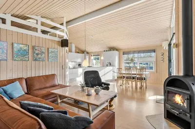 a living room with a couch and a wood stove at LK1902-Lokken-Olgavej-40 in Løkken