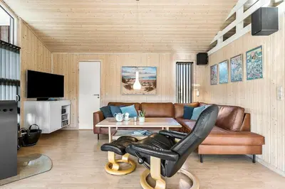 a living room with a couch and a table at LK1902-Lokken-Olgavej-40 in Løkken