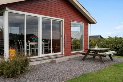 a picnic table in front of a red house at G228-Lemvig-Myntevej-28 in Lemvig