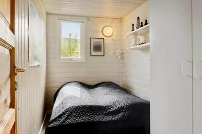 a small room with a bed and a window at G228-Lemvig-Myntevej-28 in Lemvig
