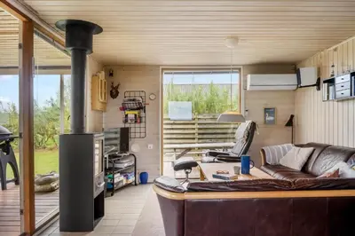 a living room with a couch and a fireplace at G228-Lemvig-Myntevej-28 in Lemvig