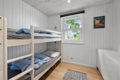 a room with two bunk beds and a window at LK2185-Lokken-Marthinesvej-17 in Løkken
