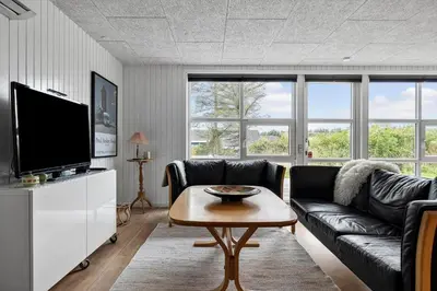 a living room with a couch and a table at LK2185-Lokken-Marthinesvej-17 in Løkken