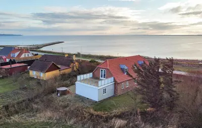 an aerial view of a group of houses next to the water at Pet Friendly Home In Vestervig With Sauna in Vestervig
