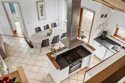 an overhead view of a kitchen with a table and a stove at 70721-Ulfborg-Klitengene-11 in Ulfborg