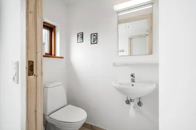 a white bathroom with a toilet and a sink at 70721-Ulfborg-Klitengene-11 in Ulfborg