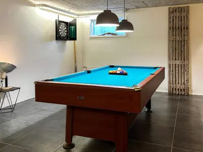 a pool table in a room with a blue at Family-Friendly House with Sauna in Pandrup