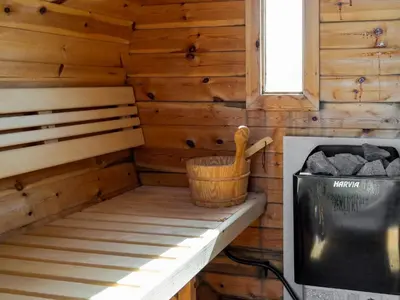 a wooden cabin with a tv and a wooden basket at Family-Friendly House with Sauna in Pandrup
