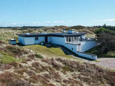 a house in the middle of a field at Family-Friendly House with Sauna in Pandrup