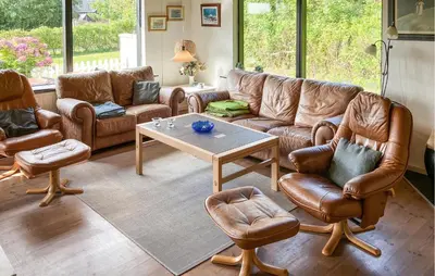 a living room with leather furniture and a table at Pet Friendly Home In Struer With Wifi in Struer