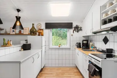 a kitchen with white appliances and a window at JB162-Fjerritslev-Ronnevej-4 in Fjerritslev