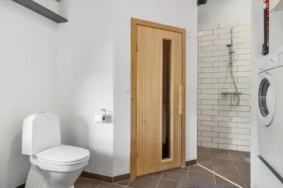 a bathroom with a toilet and a washing machine at JB403-Fjerritslev-Poppelvej-20 in Fjerritslev