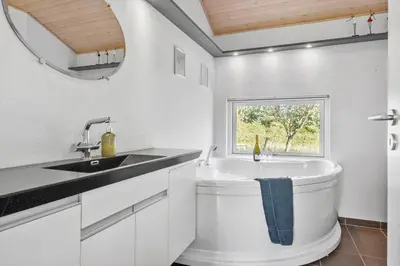 a white bathroom with a sink and a window at JB403-Fjerritslev-Poppelvej-20 in Fjerritslev