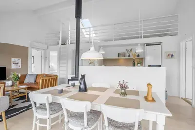 a kitchen and dining room with a table and chairs at JB366-Brovst-Kronvildtvej-118 in Brovst