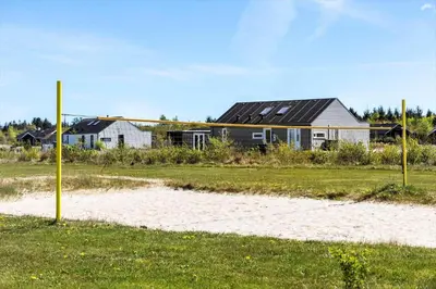 a house in a field next to a beach at JB366-Brovst-Kronvildtvej-118 in Brovst