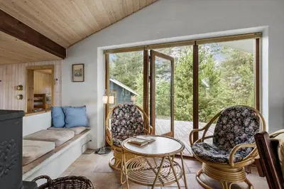a living room with a couch and a table and chairs at JB363-Fjerritslev-Tolderstien-8 in Fjerritslev