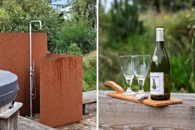 a bottle of wine and two glasses on a table at LK2174-Lokken-Stellavej-18 in Løkken