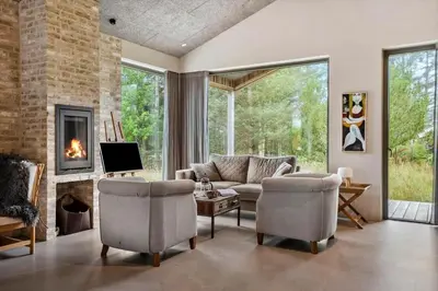 a living room with a couch and a fireplace at LK2174-Lokken-Stellavej-18 in Løkken
