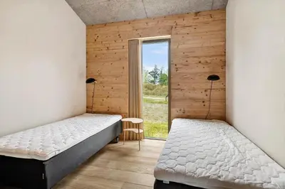 a bedroom with two beds and a window at LK2174-Lokken-Stellavej-18 in Løkken