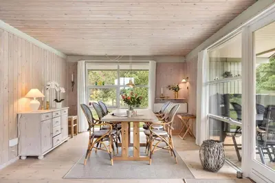 a dining room with a table and chairs at LK2178-Lokken-Sarasvej-48 in Løkken