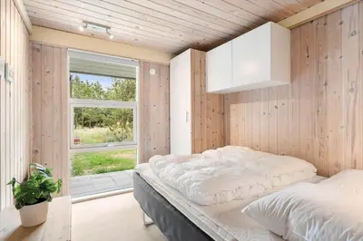 a bedroom with a bed and a window at LK2178-Lokken-Sarasvej-48 in Løkken