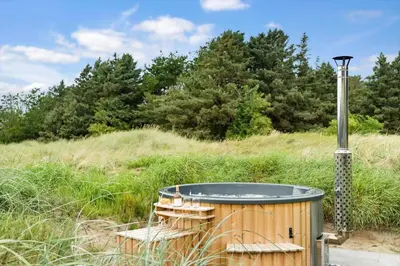 a wooden hot tub in the middle of a field at LK2178-Lokken-Sarasvej-48 in Løkken
