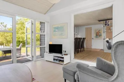 a living room with a tv and a chair and a table at LF21632-Spottrup-Rylevej-1 in Spottrup