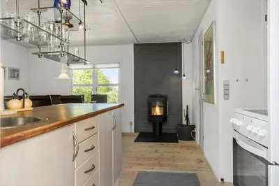 a kitchen with a stove in the middle of a room at LF21632-Spottrup-Rylevej-1 in Spottrup