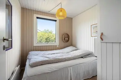 a bed in a small room with a window at G322-Lemvig-Gyvelvej-22 in Lemvig