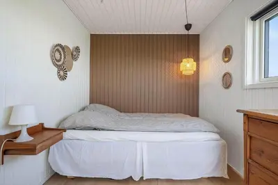 a small bedroom with a bed and a window at G322-Lemvig-Gyvelvej-22 in Lemvig