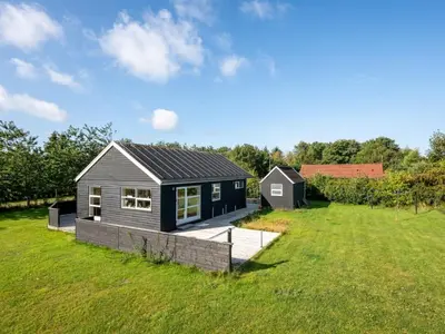 a small house in a field with a yard at Holiday Home Anja - 550m to the fjord by Interhome in Vemb